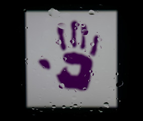 Purple hand, LGBT theme. Abstract photo with water drops on glass.