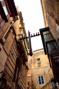 votive cross in a narrow street of Malta