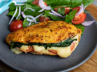 Baked chicken fillet stuffed with spinach, tomatoes and cheese