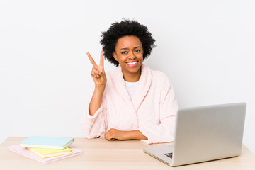 Middle aged african american woman working at home isolated showing number two with fingers.