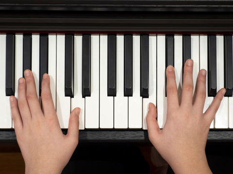 a young lady plays the piano