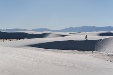 A man walking in the distance at White Sands National Park in Alamogordo, New Mexico. 