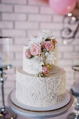 Obraz na płótnie Canvas Table with a wedding cake, candles and flowers.