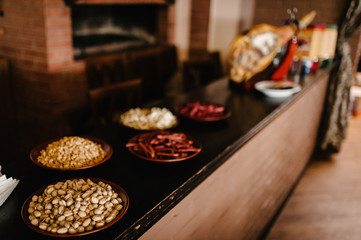 Snacks to beer in plate isolated on background table. Snacks, nuts, pistachios, rusks, dried meat.