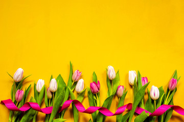 ColorfulTulip Spring Flowers. Yellow And Pink Blossoms With Pink Ribbon. Yellow Wooden Background