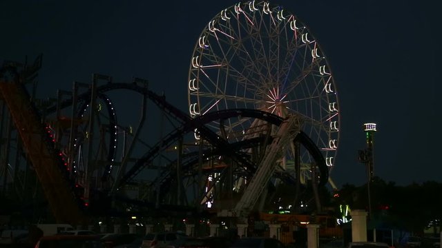 Extreme amusement park with lighting in the evening