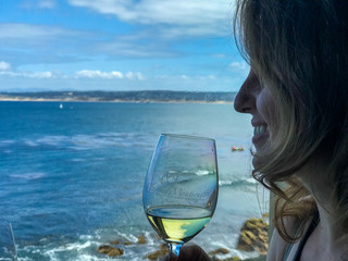 woman with glass of wine on the beach