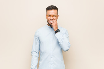 Young south-asian business man biting fingernails, nervous and very anxious.