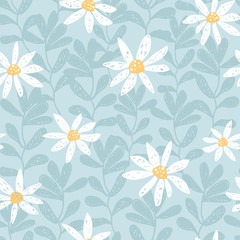Hand drawn seamless vector pattern with chamomile flowers and leaves. White daisy on a blue background. Tender ditsy illustration perfect fo fabrics.