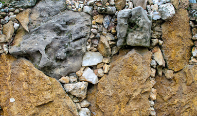 Background of a stone multi-colored detrital structure close-up.