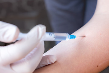 doctor makes an injection to the patient, blood sampling for analysis close
