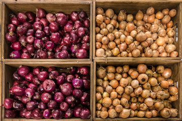 baskets with sweet red and yellow onions in the mall