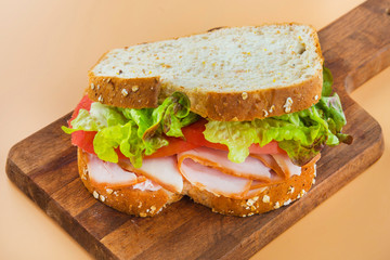 Sandwich of tomato, lettuce and smoked turkey