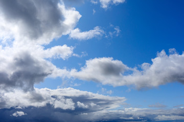 Fototapeta premium gloomy cloudy clouds light with a dark bottom against the blue sky in summer