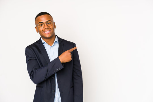 Young business latin man isolated on white background smiling and pointing aside, showing something at blank space.