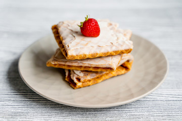  Waffles and strawberries on a grey wooden background. Dessert with berries.