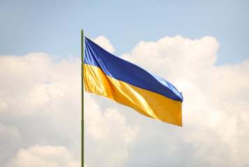 The national flag of Ukraine is developing. Blue and yellow banner. Symbol of the country. Blue sky...