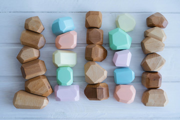 Educational games for children. Wooden figures of different sizes, shapes and colors.