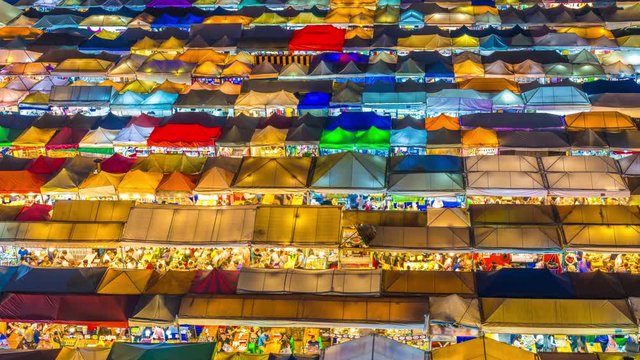 Time lapse of Train night market Ratchada Thailand Is a tourist attraction, eating and shopping for tourists From an aerial perspective, the roof is colorful and beautiful
