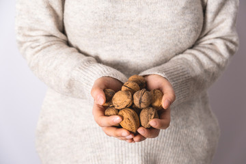Shelled walnuts in woman handful. Delicious and healthy snacks, foods.