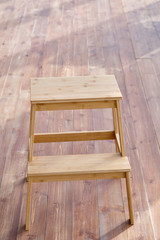 Rustic wooden chair on a wooden deck.