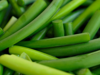 Sliced garlic sticks are very tender and delicious. They are also known as garlic spears , stems , or tops .