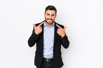 Young caucasian business man against a white background isolated smiles, pointing fingers at mouth.