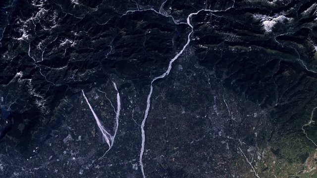 Gravel rivers confluence from mountains to cultivated agricultural land sunrise animation, aerial satellite view of Tagliamento river, Italy. Images furnished by Nasa