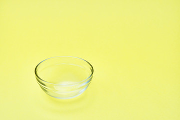 empty glassware. bowl on yellow background. copy space
