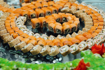 Plate with sushi rolls serving in the restaurant. Delicious Asian food and japanese food. Japanese Cuisine - Fresh Vegetarian Maki Sushi