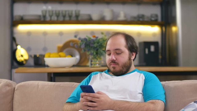 Portrait of obese guy download app for his cellphone.