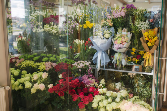 Different varieties fresh spring flowers in refrigerator room for flowers. Beautiful flowers in cold room with air conditioning. Bouquets on shelf, florist business in refrigerator for flowers. Tulinp