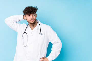 Young arab doctor man idolated touching back of head, thinking and making a choice.