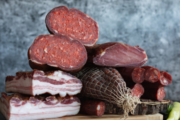 A set of different types of raw smoked meat. Ham, bacon, sausage.