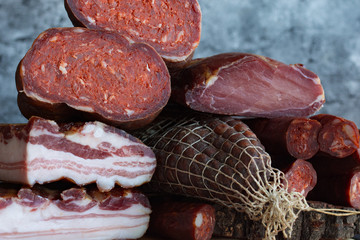 A set of different types of raw smoked meat. Ham, bacon, sausage.