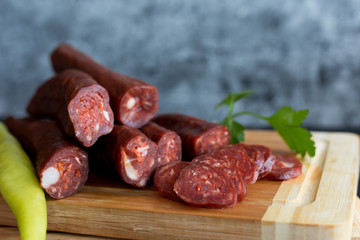 Delicious sausages served on wooden table.