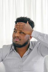 Obraz premium African american, arabian man suffering from headache desperate and stressed because pain and migraine. Hand on head. Negative emotion expression.