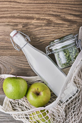 Zero waste, plastic-free and eco-friendly lifestyle and shopping. Cotton mesh bag, products in glass jar and fresh fruits