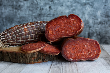 Delicious sausages served on dark background.
