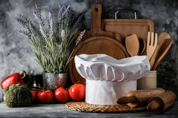 White cook hat in kitchen and free space for your decoration 