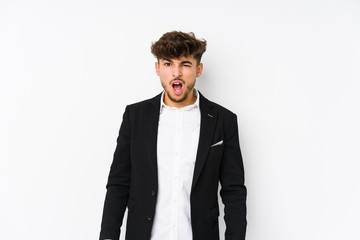 Young arabian business man isolated screaming very angry and aggressive.