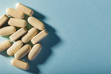 Colorful pills on a blue background.