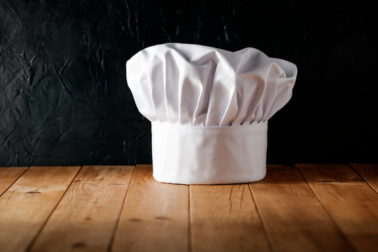 White cook hat in kitchen and free space for your decoration 