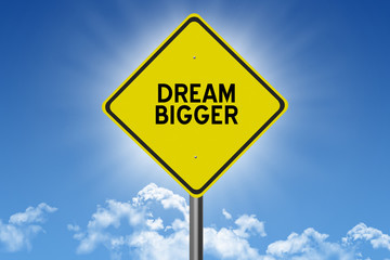 Dream Bigger inspirational quote on sky background for success in planning and goals concept.