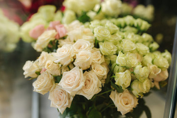 Different varieties fresh spring flowers in refrigerator room for flowers. Beautiful flowers in cold room with air conditioning. Bouquets on shelf, florist business in refrigerator for flowers. Tulinp