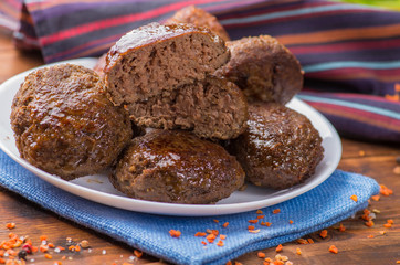 cutlet cut in half on the background whole on a plate