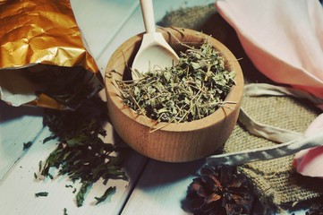 medicinal herbs, traditional medicine, thyme on a wooden spoon with natural ingredients