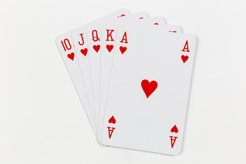 Royal straight flush in hearts, playing cards isolated on white background