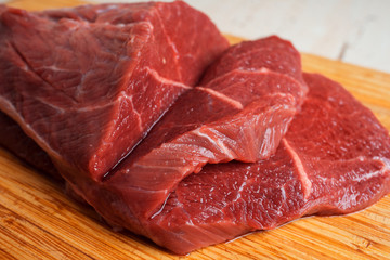 Red meat beef close-up on a wooden background
