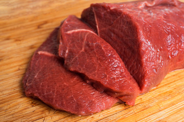 Red meat beef close-up on a wooden background